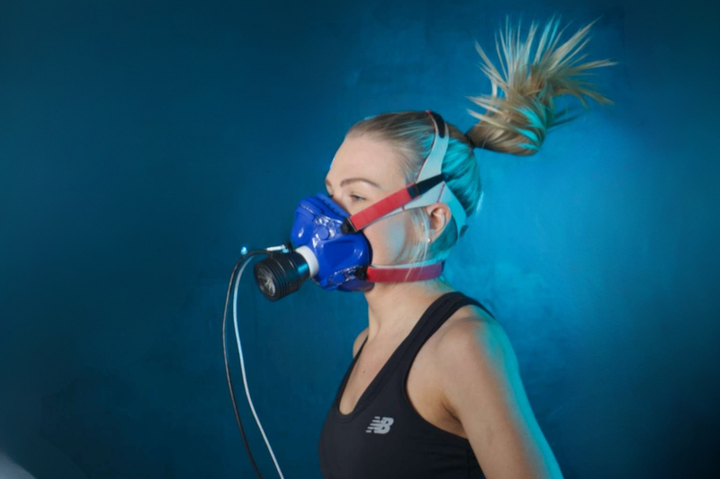 Person wearing a blue oxygen mask against a blue background