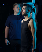 Two men standing next to each other with a blue filter effect.