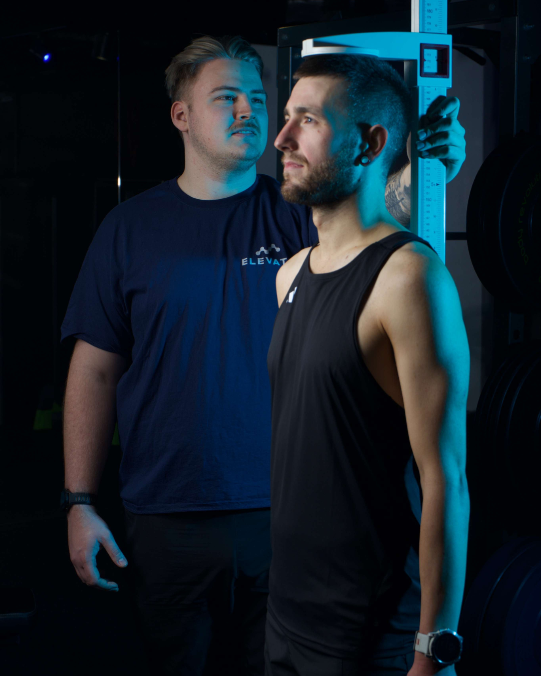Two men standing next to each other with a blue filter effect.