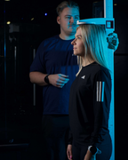 Person getting their height measured with a device in a dark setting